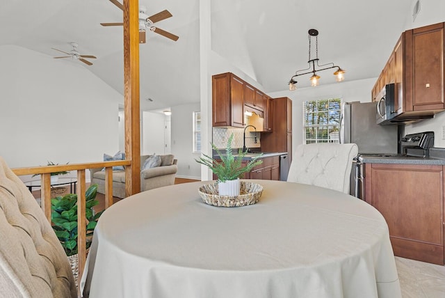 dining space featuring vaulted ceiling and visible vents