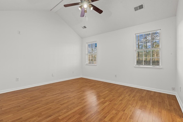 empty room featuring light wood-style floors, plenty of natural light, and visible vents