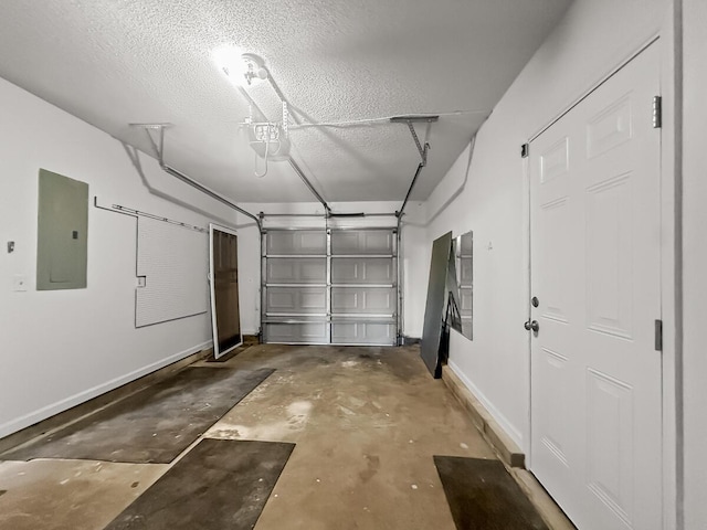 garage featuring electric panel and baseboards