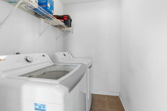 laundry room with separate washer and dryer, tile patterned floors, and baseboards