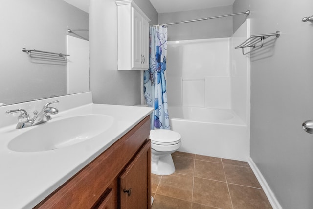 bathroom with toilet, vanity, tile patterned flooring, shower / bath combo with shower curtain, and baseboards