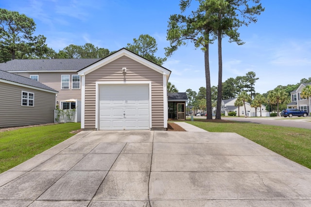 view of front of property featuring a front yard, driveway, and a garage