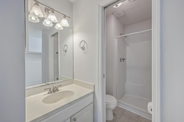 bathroom featuring toilet, a textured ceiling, a shower, and vanity