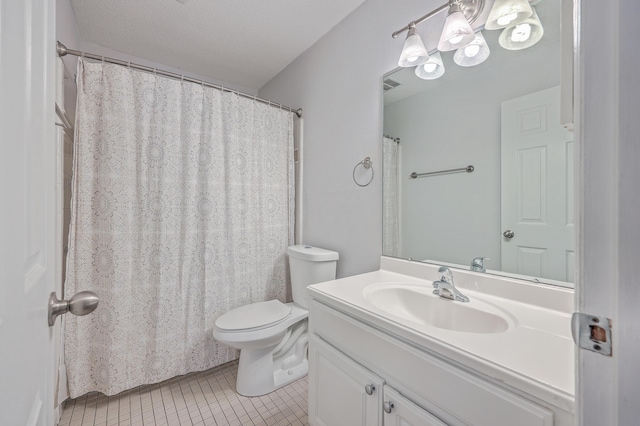 bathroom featuring a textured ceiling, vanity, tile patterned floors, and toilet