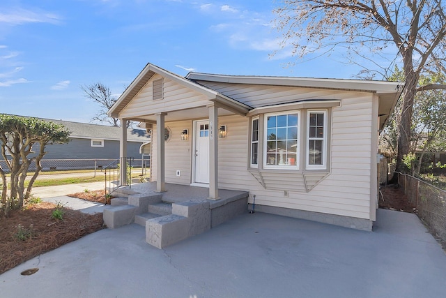 view of front facade featuring a patio area and fence