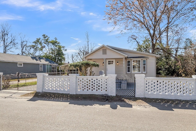 view of front of property with a fenced front yard and a gate