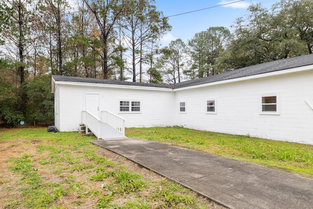 back of property featuring a lawn