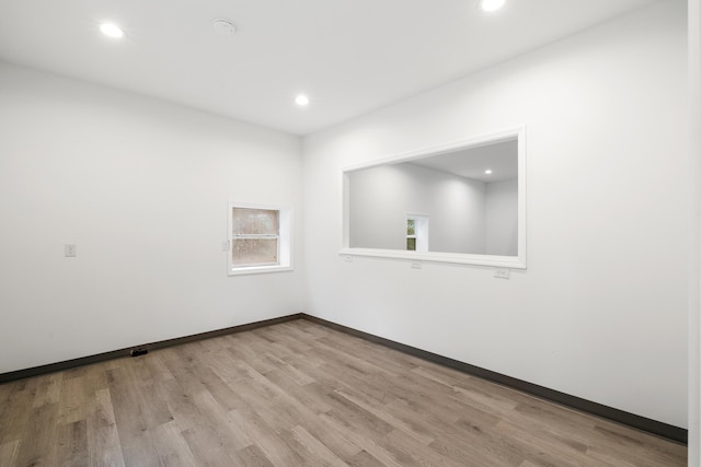 unfurnished room with light hardwood / wood-style floors