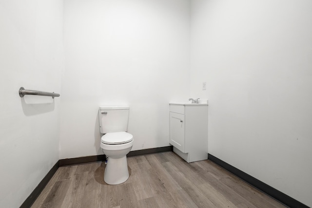 bathroom featuring hardwood / wood-style floors, vanity, and toilet