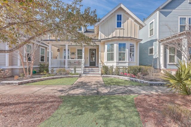 view of front of house with a front yard and a porch