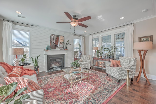 living room with ceiling fan, dark hardwood / wood-style floors, and crown molding