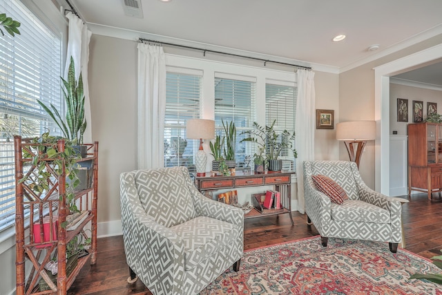 sitting room featuring dark wood-type flooring and crown molding