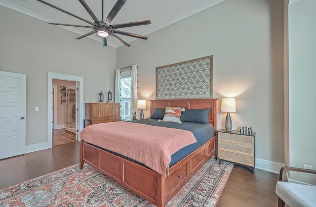 bedroom with a spacious closet, ceiling fan, a closet, and dark wood-type flooring