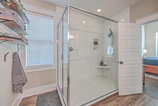 bathroom with an enclosed shower and a wealth of natural light