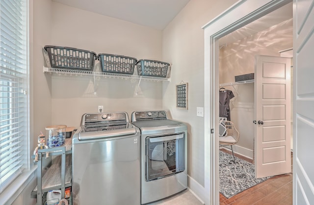 washroom with independent washer and dryer and light hardwood / wood-style floors