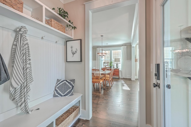 mudroom with dark hardwood / wood-style flooring and a notable chandelier