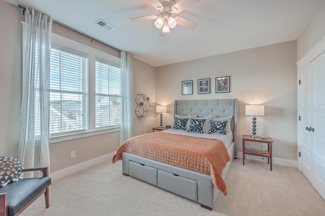 bedroom with light carpet and ceiling fan