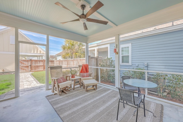 sunroom / solarium featuring ceiling fan and vaulted ceiling