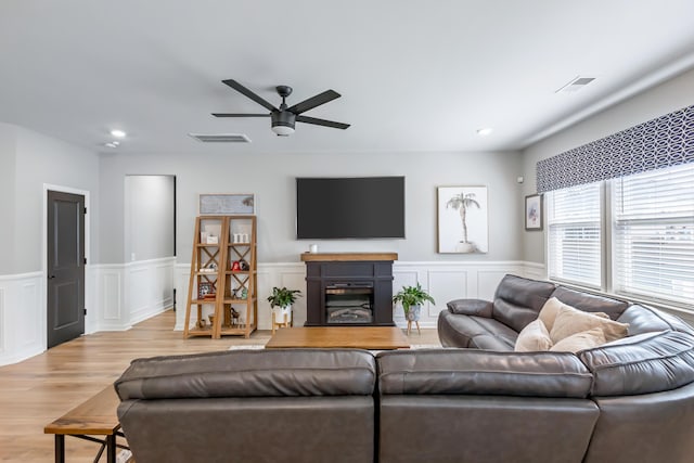 627 Macintyre Cir, Summerville, SC 29486 - living room with ceiling fan, light wood-type flooring, a fireplace, a wainscoted wall, and recessed lighting