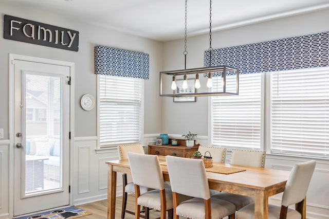627 Macintyre Cir, Summerville, SC 29486 - dining area with a decorative wall, a wainscoted wall, and light wood-style floors