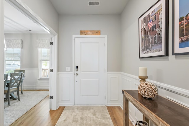 627 Macintyre Cir, Summerville, SC 29486 - foyer entrance with light wood-style floors, wainscoting, and a decorative wall