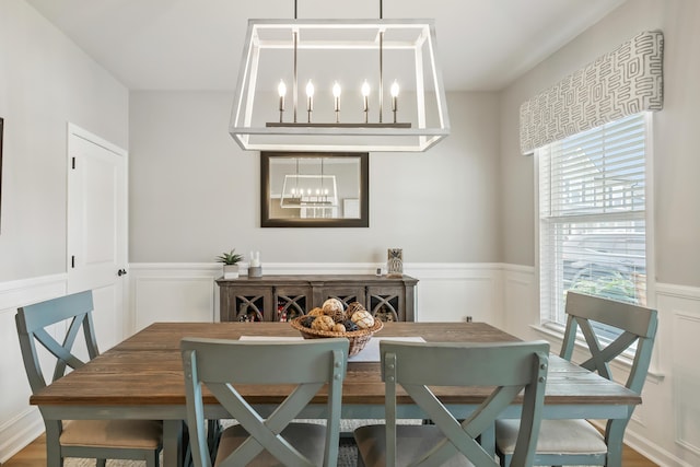 627 Macintyre Cir, Summerville, SC 29486 - dining area featuring a chandelier, a wainscoted wall, and a decorative wall