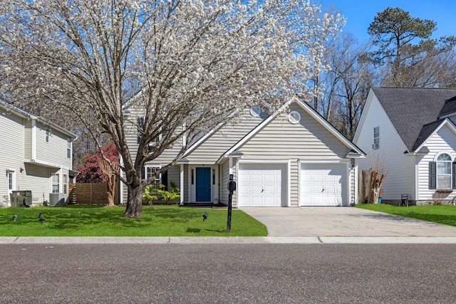 view of front of home with concrete driveway, an attached garage, and a front lawn