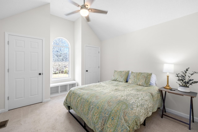 bedroom with carpet, visible vents, baseboards, and vaulted ceiling