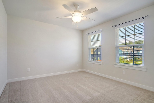 carpeted empty room featuring ceiling fan