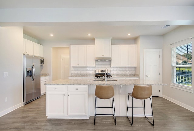 kitchen featuring a kitchen island with sink, white cabinets, sink, dark hardwood / wood-style floors, and stainless steel appliances