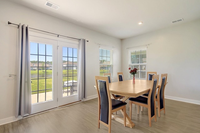 dining area featuring hardwood / wood-style flooring and a healthy amount of sunlight