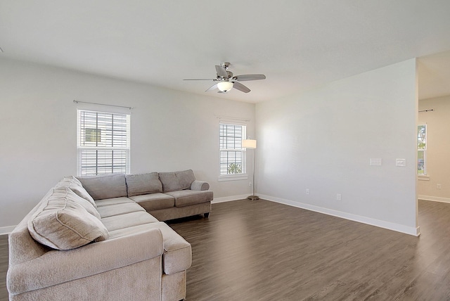 living room with dark hardwood / wood-style floors, plenty of natural light, and ceiling fan