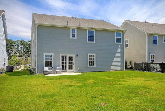 back of house with a lawn, a patio area, and central AC