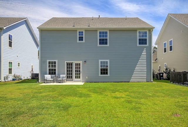 back of house featuring central AC unit, a patio area, and a yard