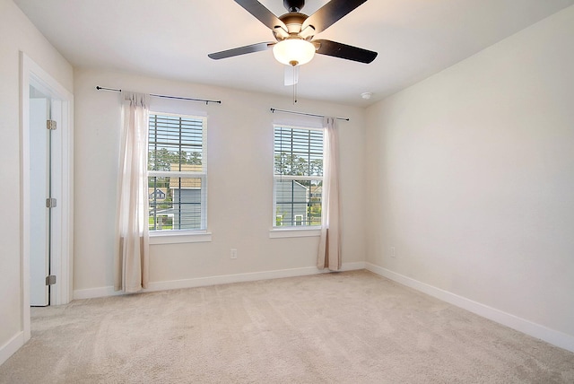 carpeted spare room with ceiling fan