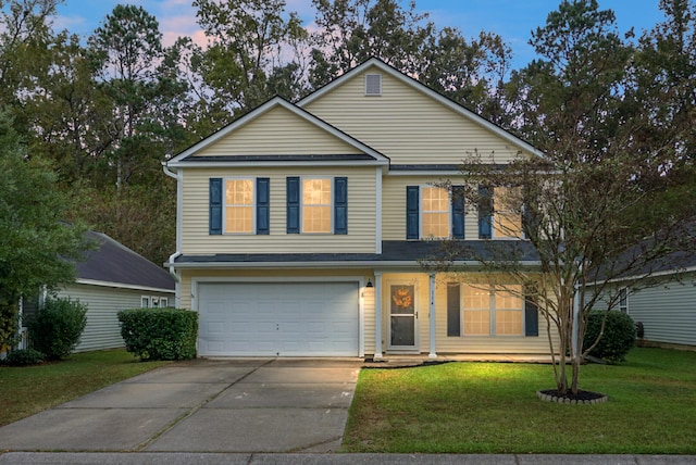 view of front of house with a lawn and a garage