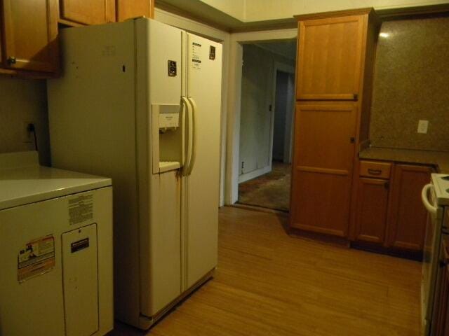 kitchen with light hardwood / wood-style floors and white appliances