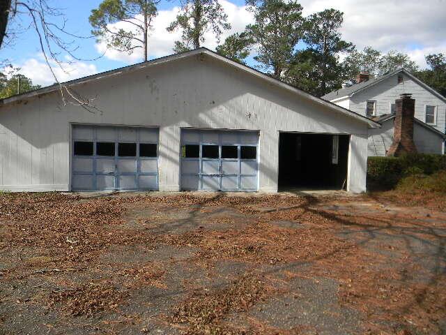 view of property exterior with an outbuilding and a garage