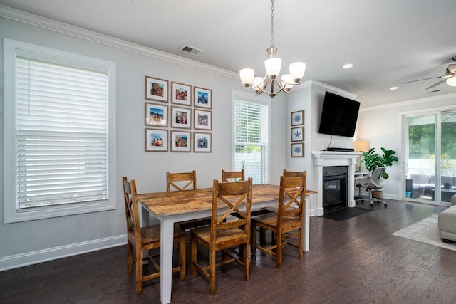 1630 Mermentau St, Mount Pleasant, SC 29466 - dining area featuring crown molding, healthy amount of natural light, dark wood finished floors, a chandelier, and a fireplace with flush hearth