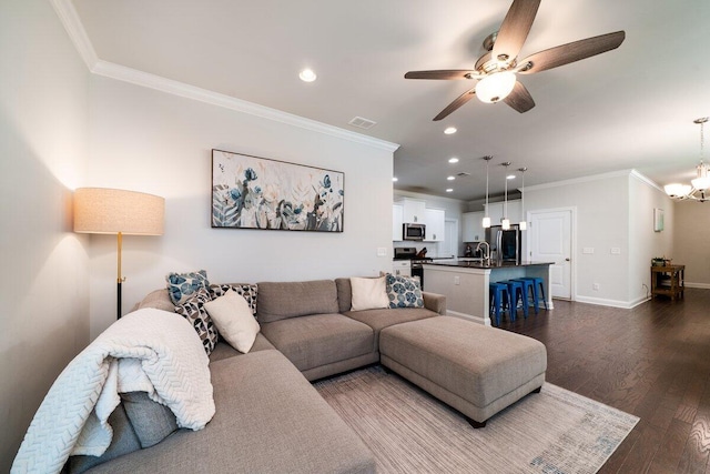 1630 Mermentau St, Mount Pleasant, SC 29466 - living area with crown molding, ceiling fan, a chandelier, recessed lighting, and dark wood-style flooring