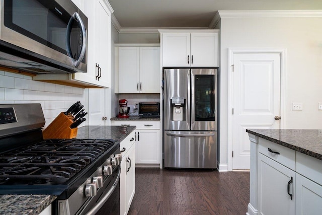 1630 Mermentau St, Mount Pleasant, SC 29466 - kitchen featuring appliances with stainless steel finishes, dark wood-style floors, white cabinetry, tasteful backsplash, and crown molding