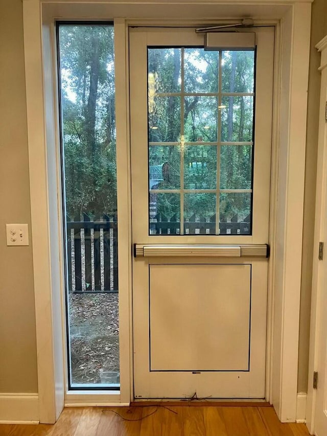 doorway with light wood-type flooring