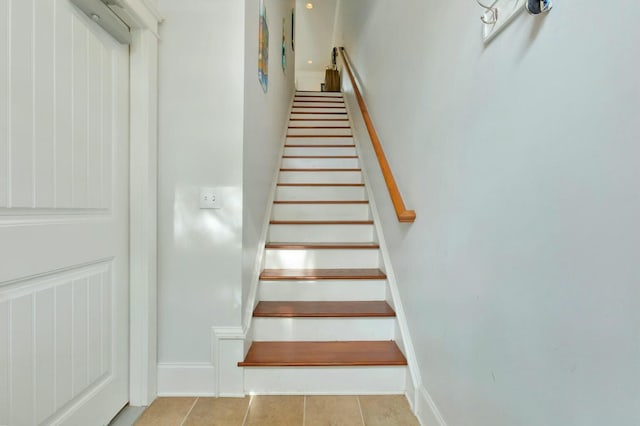 stairway with tile patterned floors