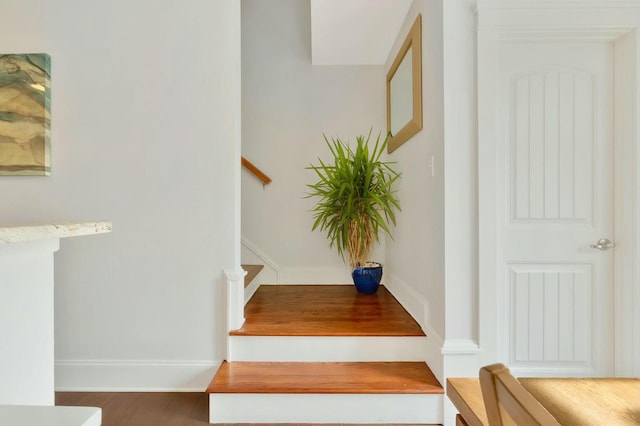 stairs featuring hardwood / wood-style flooring