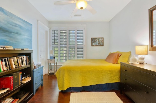 bedroom with ceiling fan and dark hardwood / wood-style flooring