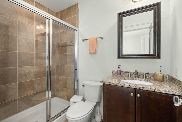 bathroom featuring walk in shower, vanity, and toilet