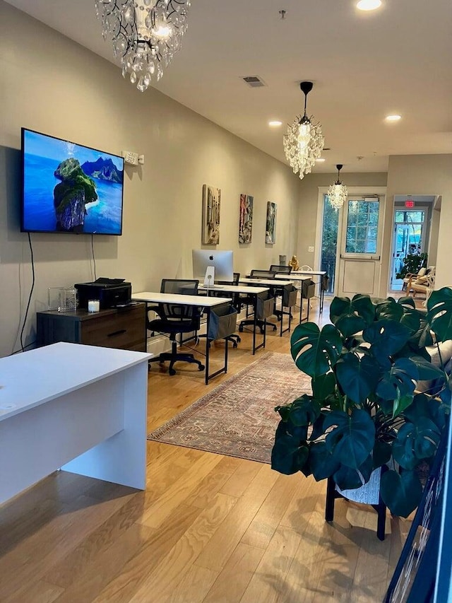 office featuring wood-type flooring and a notable chandelier