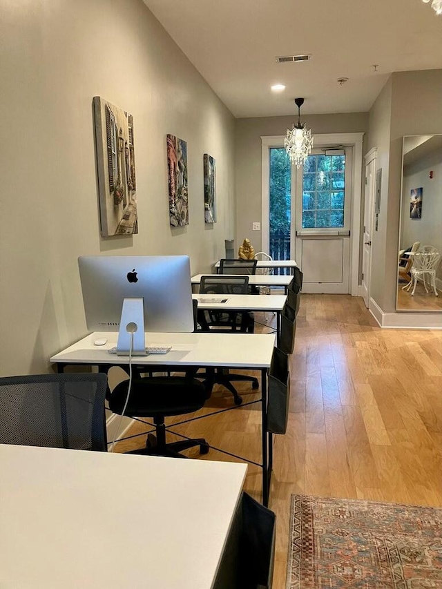 dining area with a chandelier and light wood-type flooring