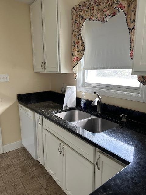 kitchen featuring dishwasher, white cabinetry, and sink