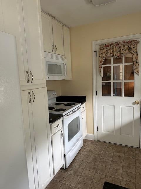 kitchen with white cabinetry and white appliances